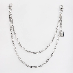 Detail of silver double-layered metal trousers chain with lobster clasps and square lock pendant