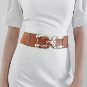 Detail of a wide brown leather belt with interlocking gold buckle on a white dress