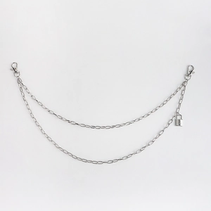 Detail of silver double-layered metal trousers chain with lobster clasps and padlock charm