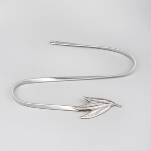 Close-up of elastic metal belt with triple leaf buckle for dresses and jackets