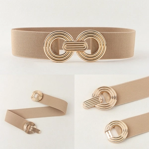 Detail view of beige elastic waist belt featuring golden interlocking circular metal buckles