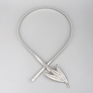 Detailed close-up of elastic silver metal waist chain with three-leaf buckle design