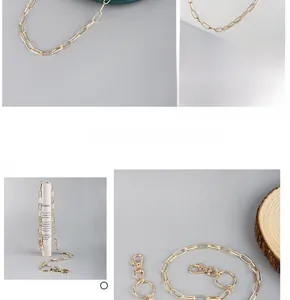 Detailed macro view of gold hollow link chain with lobster clasp and metal ring connector