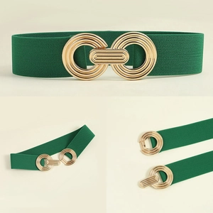 Detail view of forest green elastic belt featuring a golden interlocking geometric buckle