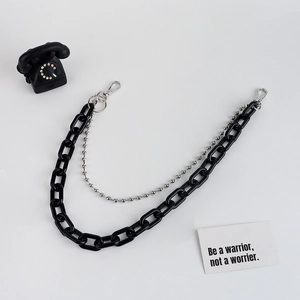 Detail of double-layer punk trouser chain with black chunky links and silver bead chain