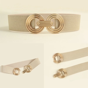 Close-up detail of geometric gold metal buckle on beige elastic waist belt for women
