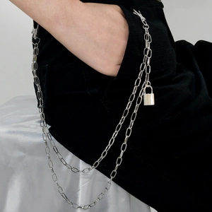 Macro shot of silver double-layer punk trousers chain with padlock pendant detail
