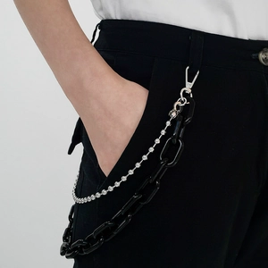 Detail of double-layer punk waist chain with black acrylic links and silver rhinestone chain