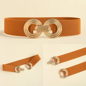 Detail of caramel brown elastic waist belt with decorative gold geometric metal buckle