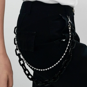 Detail of a double-layered punk waist chain with black acrylic links and sparkling rhinestones