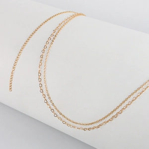 Detailed macro view of golden double-layer heart-shaped links on metal waist chain