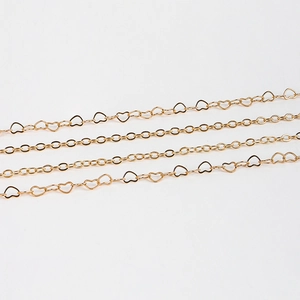 Double-layered golden metal waist chain with hollow heart links and round ring design