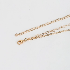 Detail of double-layer gold heart body chain featuring lobster clasp and metal links