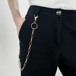 Close-up of gold hollow link hip hop waist chain on black pants with lobster clasp detail
