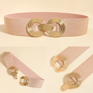 Close-up of pink elastic waist belt with textured band and gold interlocking geometric buckle