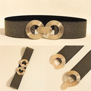 Detail of black elastic waist belt featuring a gold geometric metal interlocking buckle