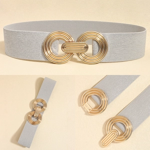 Detail of grey elastic waist belt with a interlocking triple gold metal buckle mechanism
