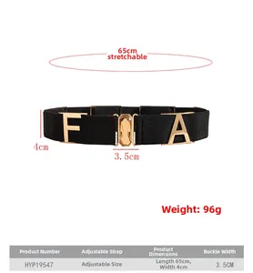 Close-up of black elastic belt with gold metal buckle featuring FA letter ornaments