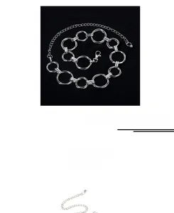 Detailed view of silver metal waist chain featuring interlocking rings and lobster clasp closure