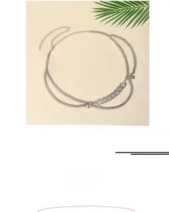Macro detail of multilayer silver chain belt with small lock pendant and 65+40cm length