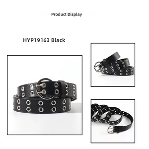 Detail view of black punk belt with double row metal eyelets and silver round buckle