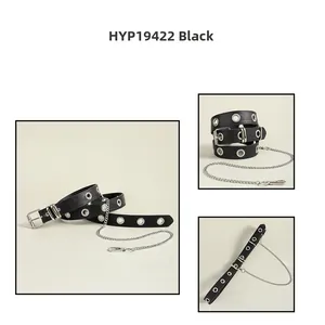 Detail of black punk leather belt with silver eyelets and detachable metal chain