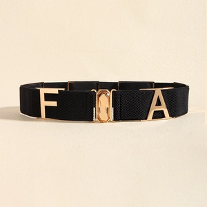 Close-up of black elastic waist belt with gold FA metal buckle on minimalist background