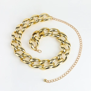 Detailed macro view of a chunky gold Cuban chain waist belt with adjustable lobster clasp