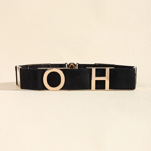 Close-up of black elastic belt featuring polished gold metal O and H buckle accents