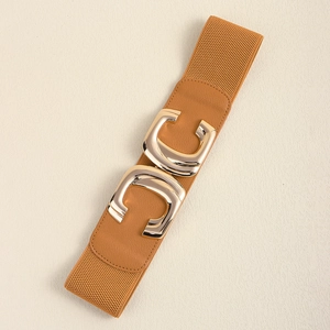 Detailed macro view of elastic waist belt with interlocking gold buckle and tan texture