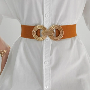 Close-up of caramel elastic waist belt with interlocking gold circular metal buckle
