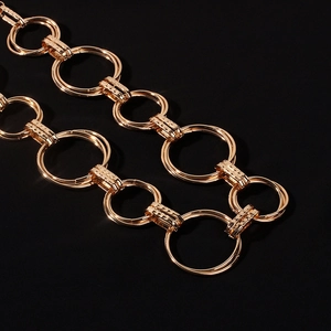 Macro shot of gold metal chain rings with textured rectangular links for waist jewelry
