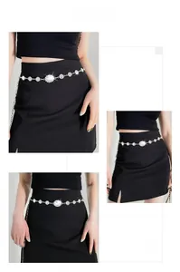 Detail of silver rhinestone waist chain with crystal flower on a black dress