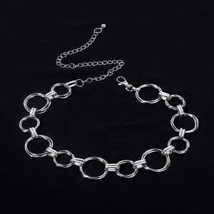 Close-up of polished silver metal waist chain with double ring links and lobster clasp