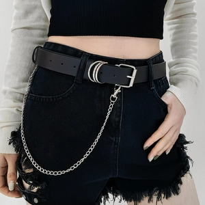 Detail of punk style black leather belt with silver chains on denim shorts for street fashion
