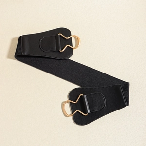 Detail of black elastic wide waist belt with premium faux leather and gold metal buckle