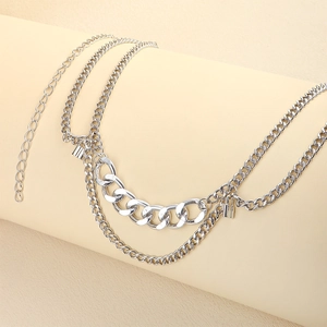 Detailed close-up of a silver multi-layer metal waist chain with a small lock pendant