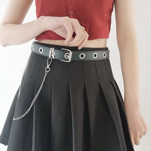 Detail of a punk style black belt with silver eyelets and long hanging metal chain accessory