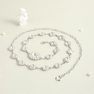 Detail of silver chain belt with round and oval rhinestones featuring a lobster clasp