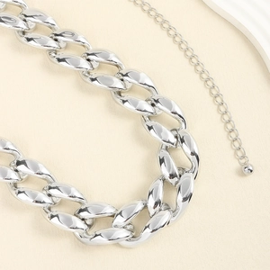 Macro shot of silver chunky curb chain waist belt with adjustable extension and bead detail