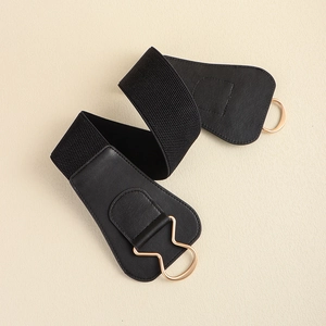 Detail of black wide elastic belt for dresses featuring a stylish gold metal buckle