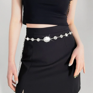 Close-up of elegant silver chain belt featuring sparkling rhinestones and floral design