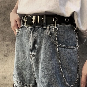 Punk style black belt with silver eyelets and detachable long metal chain on denim