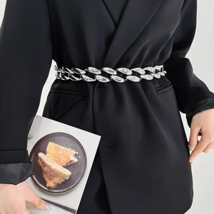 Punk style chunky silver metal chain belt accessory for women styled on a black blazer coat
