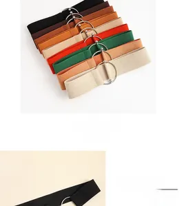 Detail view of elastic waist belt with textured fabric and polished silver circular buckle