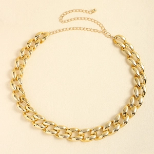 Close-up of golden chunky chain belt with large oval links and lobster clasp closure