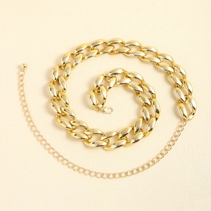 Detailed macro view of gold chunky chain belt with lobster clasp and ball pendant