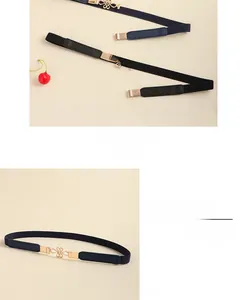 Detail of slim waist belts with golden floral metal buckle in black and navy leather