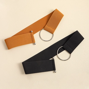 Detail of two elastic waist belts in black and yellow with round metal rings