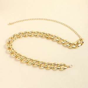 Close-up of chunky gold chain belt featuring adjustable lobster clasp and metal links
